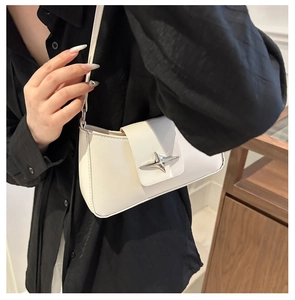 Detail of white minimalist underarm bag featuring a silver star-shaped metallic buckle