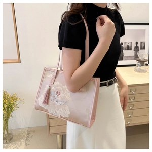 Détail du sac cabas en soie rose avec broderie de pivoine et pendentif à pampilles