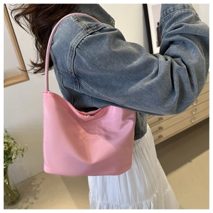 Pink satin hobo shoulder bag with onwards and upwards embroidery on casual outfit