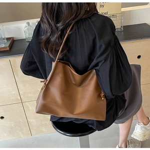 Brown soft leather tote bag with stylish knot detail and thin shoulder strap back view