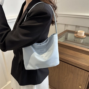 Sky blue nylon shoulder bag with onwards and upwards embroidery on the front