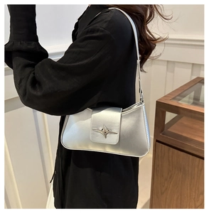 Silver metallic baguette underarm bag featuring a minimalist four-pointed star metal buckle