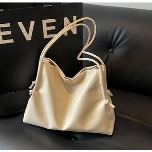 Detailed view of cream white tote bag with knot drawstring and dual slim shoulder straps