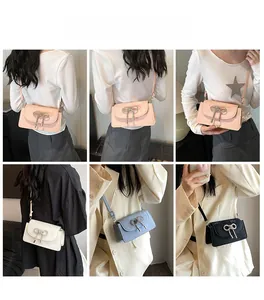 Detailed view of the rhinestone bow decoration on four colorful square crossbody bags