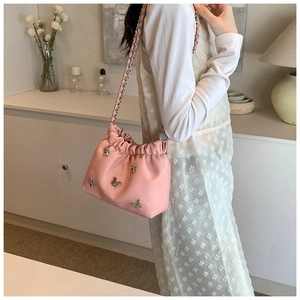 Rosa Beuteltasche mit silbernen Metallschmetterlingen und Kordelzug am Model