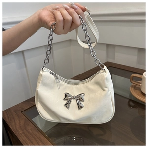 White hobo shoulder bag with a silver metal bow and chain strap in casual style