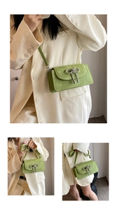 Detail of green crossbody bag featuring a rhinestone bow and adjustable shoulder strap