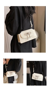 Detail view of cream crossbody bag featuring a sparkling silver rhinestone bow decoration