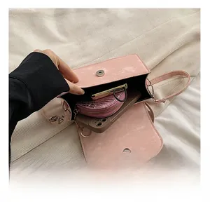Pink crossbody bag interior view showing storage space for phone and small wallet
