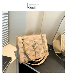 Detail of khaki quilted shoulder bag featuring gold SS logo and chain strap texture