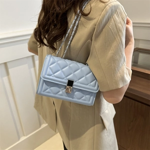 Chic light blue quilted chain crossbody bag with silver twist lock shown on model