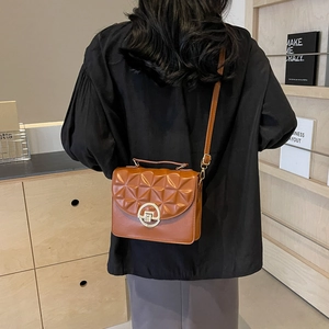 Retro caramel crossbody bag with geometric embossed flap and round gold buckle