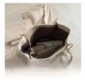Interior view of spacious white tweed tote bag showing storage for umbrella and wallet