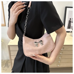 Detailed view of pink moon bag with silver bow buckle and stylish chain strap accessory