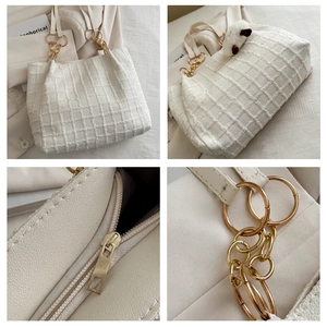 Macro detail of white lattice tote bag showing golden chain, zipper, and plush lamb charm