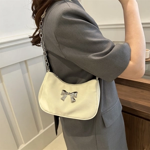 Chic white underarm bag with silver bow detail and metal chain strap for women