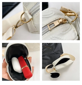Detail of white textured crossbody bag with heart embossing and detachable coin purse