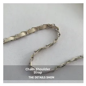 Detail of woven chain strap featuring silver metal links and cream leather texture