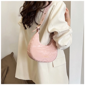 Detail of pink hobo bag with marble texture, gold zipper, and wide shoulder strap