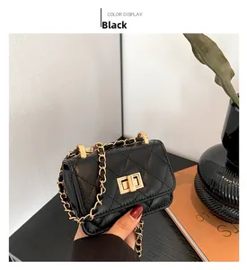 Close-up of black quilted mini bag with gold chain strap and metallic twist lock