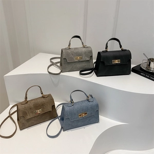 Retro trapezoid handbags in gray, black, mocha, and denim blue with gold twist locks
