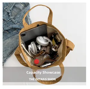 Macro detail of large capacity corduroy tote bag showing interior storage for daily items