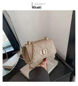 Detailed shot of khaki quilted small square bag with golden chain and turn-lock