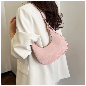 Detailed close-up of pink crescent underarm bag with marble texture and gold lettering