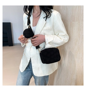 Detail of crossbody square bag with embossed heart pattern and mini round pouch