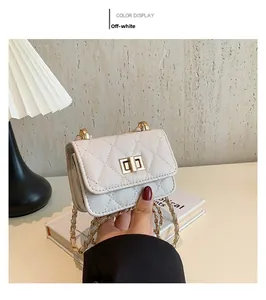 Detail of off-white quilted crossbody bag with gold-tone metal twist lock closure