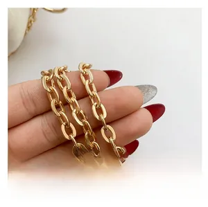 Close-up of a chunky golden metal shoulder strap chain for fashion handbags with a glossy finish