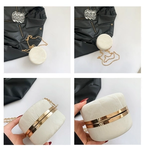 Detail of round cream shell purse with gold metal frame and elegant chain strap