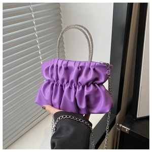 Detailed shot of purple pleated cloud bag featuring a sparkling rhinestone handle and chain