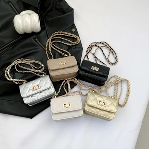 Quilted mini crossbody bag with chain strap in five colors on black leather background