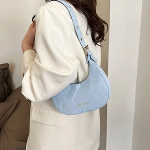Chic light blue crescent underarm bag in wrinkled patent leather with adjustable strap