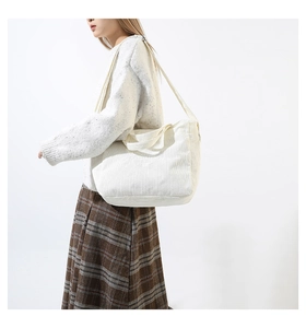 Detail of cream corduroy tote bag showing soft ribbed texture and versatile shoulder straps