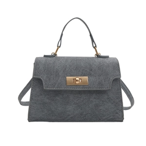 Chic grey matte trapezoid handbag with gold lock and detachable shoulder strap