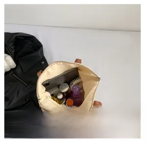 Top view of large straw tote bag showing spacious interior with tablet and cosmetics