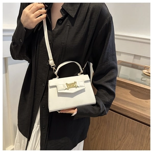 Detailed shot of white PU leather crossbody bag featuring a decorative gold chain strap