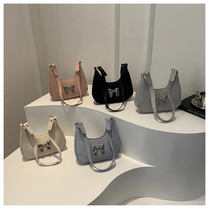 Collection of half-moon underarm bags in five colors with metal bow decoration