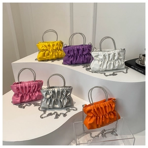 Group of pleated clutch bags with rhinestone ring handles and metal chain straps