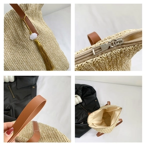 Detailed close-up of straw woven tote showing zipper, leather strap and floral pendant