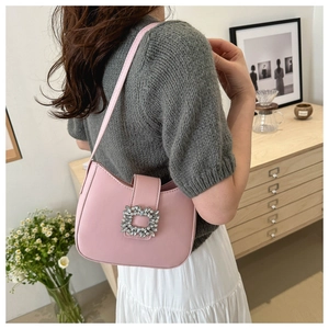 Pink underarm bag detail featuring a sparkling crystal square buckle and smooth PU finish