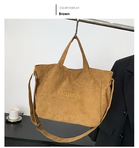 Detailed texture of brown corduroy tote bag with Fashion embroidery and adjustable strap