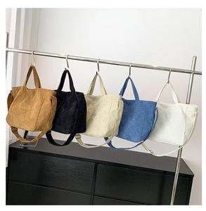 Close-up of corduroy tote bags in five colors featuring embroidered fashion lettering