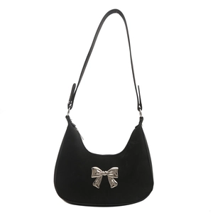 Minimalist black hobo shoulder bag with a silver metal bow accent on high-quality suede