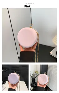 Detail showing pink round chain bag with ruffled texture and golden metal handle and frame