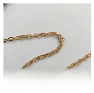 Close-up of a polished gold metal chain strap for women handbag with smooth O-rings