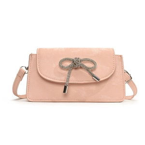 Chic pink crossbody bag featuring a sparkling rhinestone bow on a matte textured finish