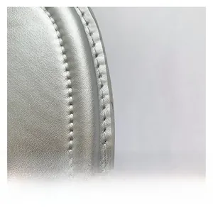Detail of silver textured leather bag with high quality stitching and metallic finish